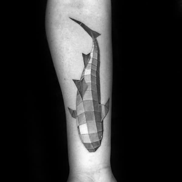Geometric koi fish tattoo on the forearm, featuring a 3D block-style design with shaded squares for a modern, artistic effect.