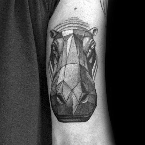 Bold geometric hippo face tattoo on the upper arm, featuring sharp angular lines and realistic shading for depth and intensity.