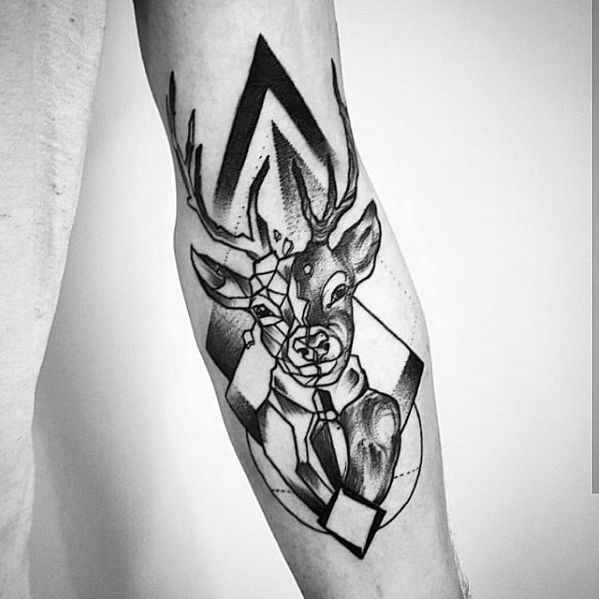 Abstract geometric tattoo of a deer with antlers on an arm, featuring bold lines and shapes in black and white.