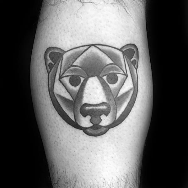 Geometric bear face tattoo with smooth shading and rounded polygonal shapes, centered on the calf for a clean, modern aesthetic.