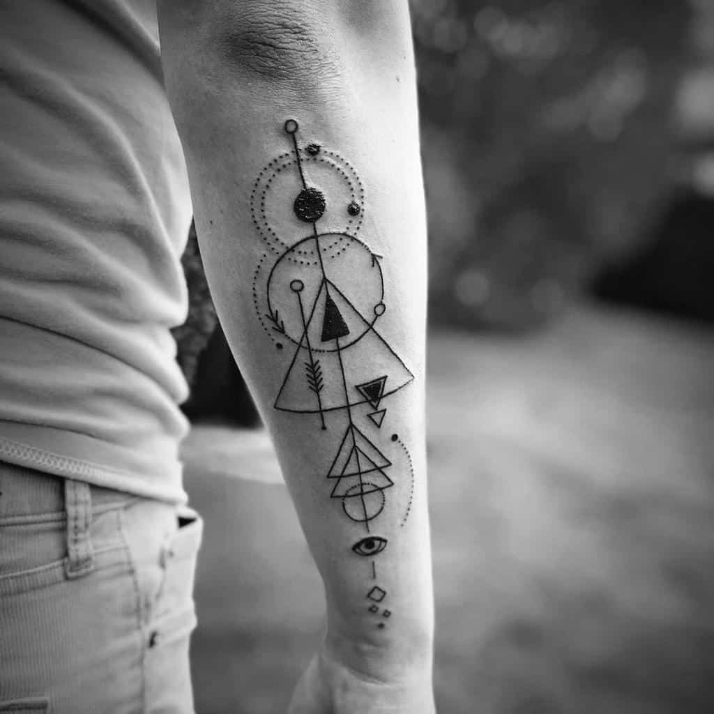 Black geometric tattoo on forearm with triangles, circles, lines, and an eye