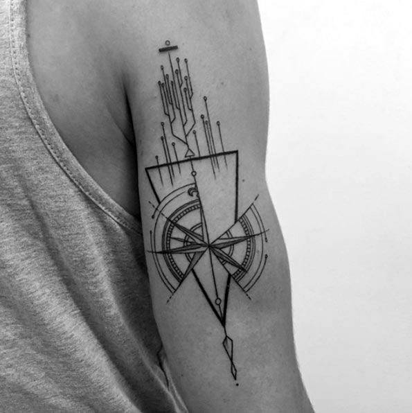 Futuristic compass tattoo on upper arm with abstract lines, triangle framing, and circuit-inspired geometric elements.