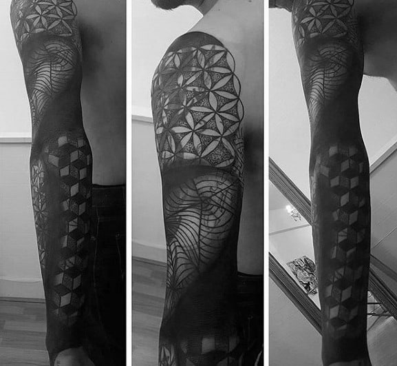 Blast over geometric blackwork tattoo sleeve on a person's arm
