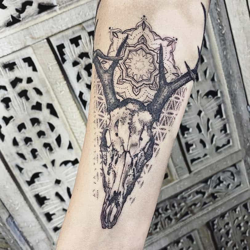 Geometric deer skull tattoo with intricate mandala patterns, combining nature and symmetry for a bold, artistic design