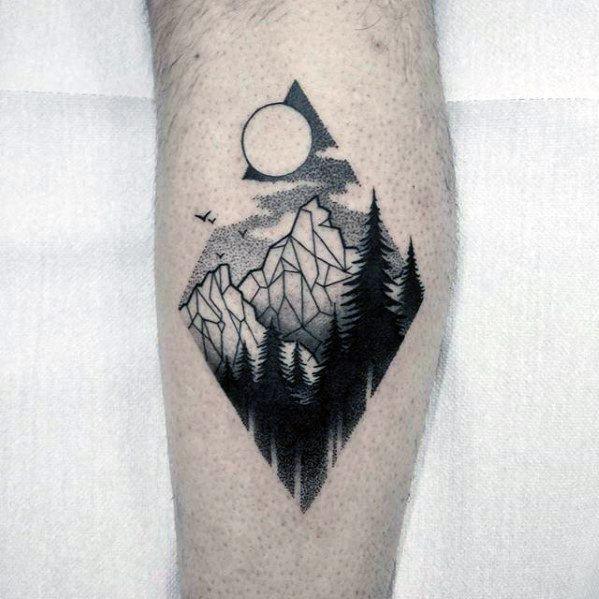 Geometric tattoo of a mountain and forest scene in a diamond frame with birds, moon, and dotwork shading in the sky.
