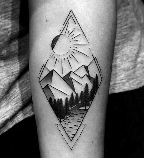 Diamond-shaped tattoo with sharp mountains, sun rays, pine trees, and a winding path for a clean, geometric nature scene.