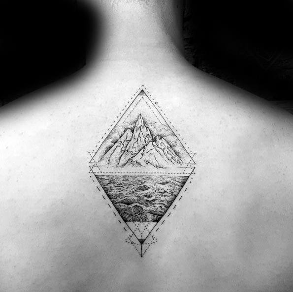 Symmetrical back tattoo with detailed mountain and ocean scenes inside overlapping diamond shapes and fine geometric linework.
