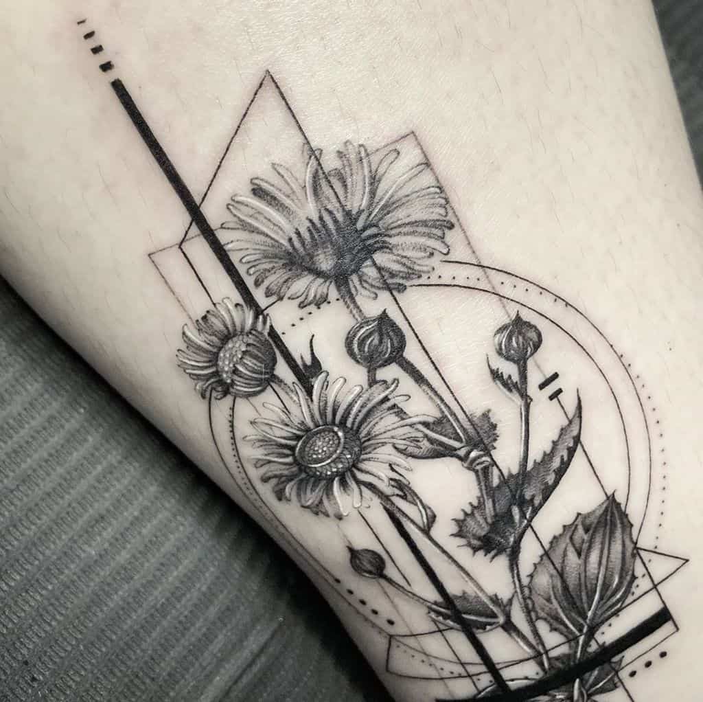 Black and grey and white geometric ornamental daisy tattoo