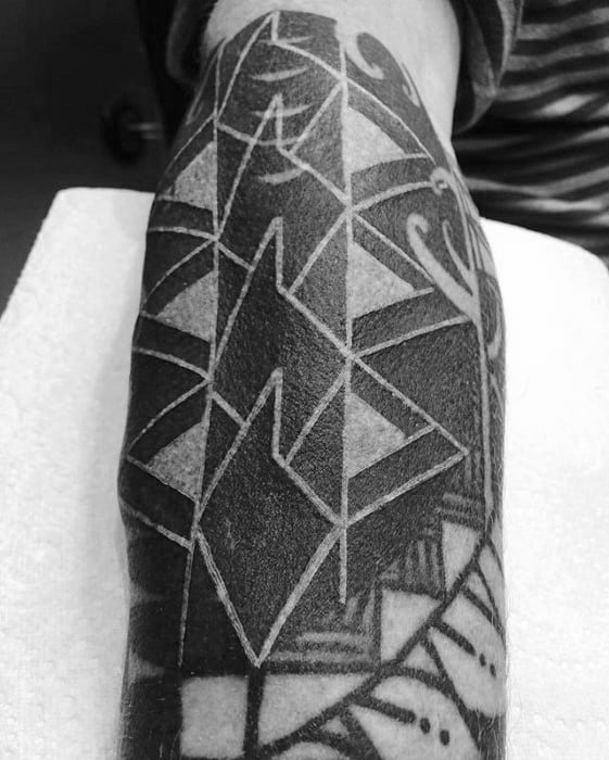 Arm with a blast over geometric tattoo design in black ink
