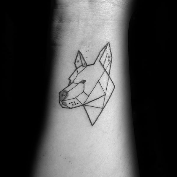 Minimalist geometric dog head tattoo on the wrist, designed with clean polygonal lines and subtle dot details for a sleek modern style.