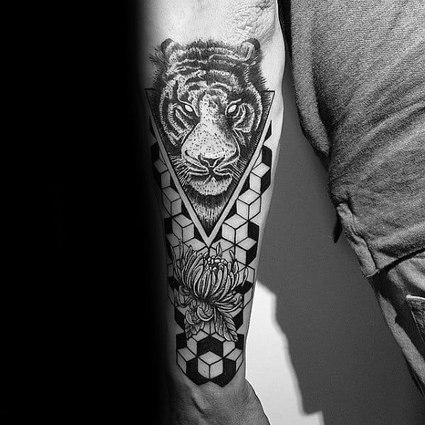 Forearm tattoo of a realistic tiger framed in a geometric triangle, with 3D cube patterns and a blooming flower for added depth.