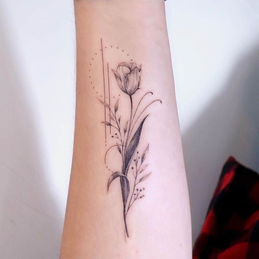 A detailed black tulip tattoo on the forearm, with delicate leaves, geometric accents, and soft shading for a minimalist yet elegant design.
