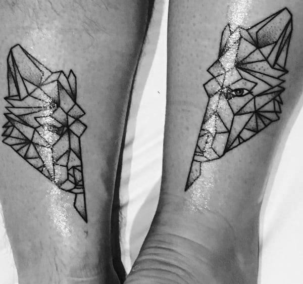 Matching geometric wolf tattoos on legs, symbolizing loyalty, strength, and a deep, instinctive connection between partners.