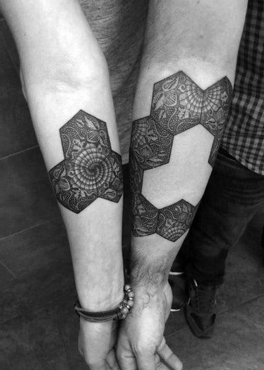 Matching forearm tattoos featuring intricate geometric hexagon patterns that complete each other when placed side by side, symbolizing unity and connection.