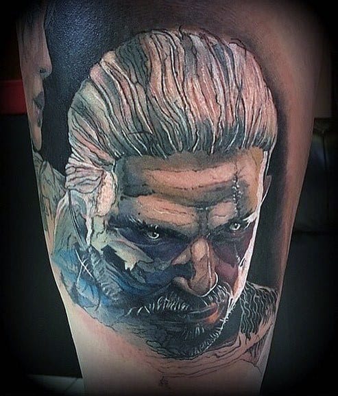 Geralt tattoo with an intense gaze, silver hair, and shadowed battle-worn face, blending realism with dark, moody tones.