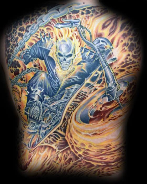 Full back Ghost Rider tattoo with a blazing skull, spiked leather suit, fiery motorcycle, and swirling flames in vivid orange and yellow.