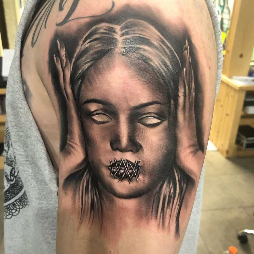 Tattoo of a woman's face with eyes closed and mouth stitched, holding her head with both hands