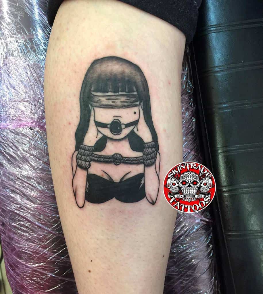 Unique tattoo of a bound figure symbolizing 'Hear No Evil, See No Evil, Speak No Evil,' featuring bold blackwork and minimalist design