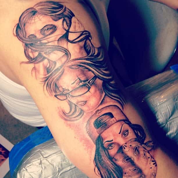 Colorful tattoo of three women symbolizing 'Hear No Evil, See No Evil, Speak No Evil,' each with distinct accessories and expressions