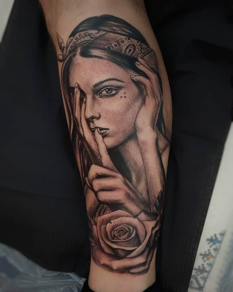 Realistic tattoo of a woman symbolizing 'Hear No Evil, See No Evil, Speak No Evil,' adorned with a bandana and a detailed rose