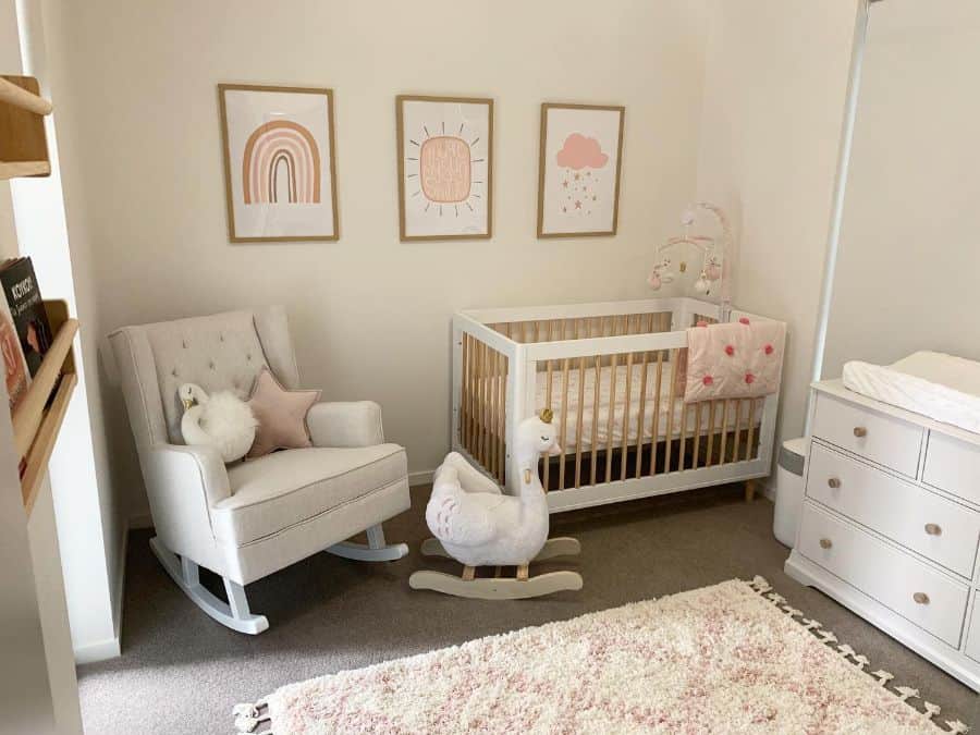simple girls nursery white cabinet crib sofa rocking chair framed wall art