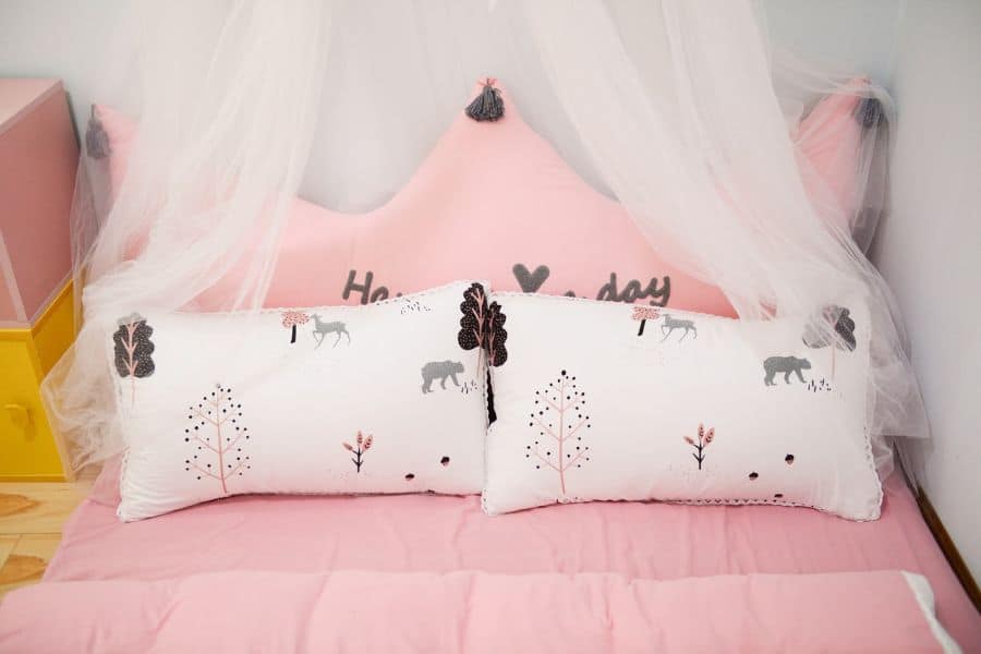pink bed white forest pattern pillows