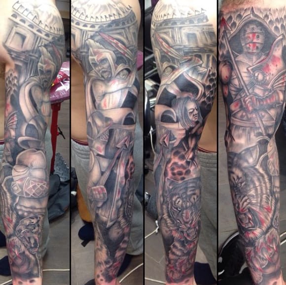 Detailed arm tattoo with knights, a gladiator, a tiger, and intricate designs