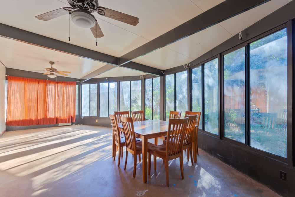 large glass enclosed patio table and chairs ceiling fans