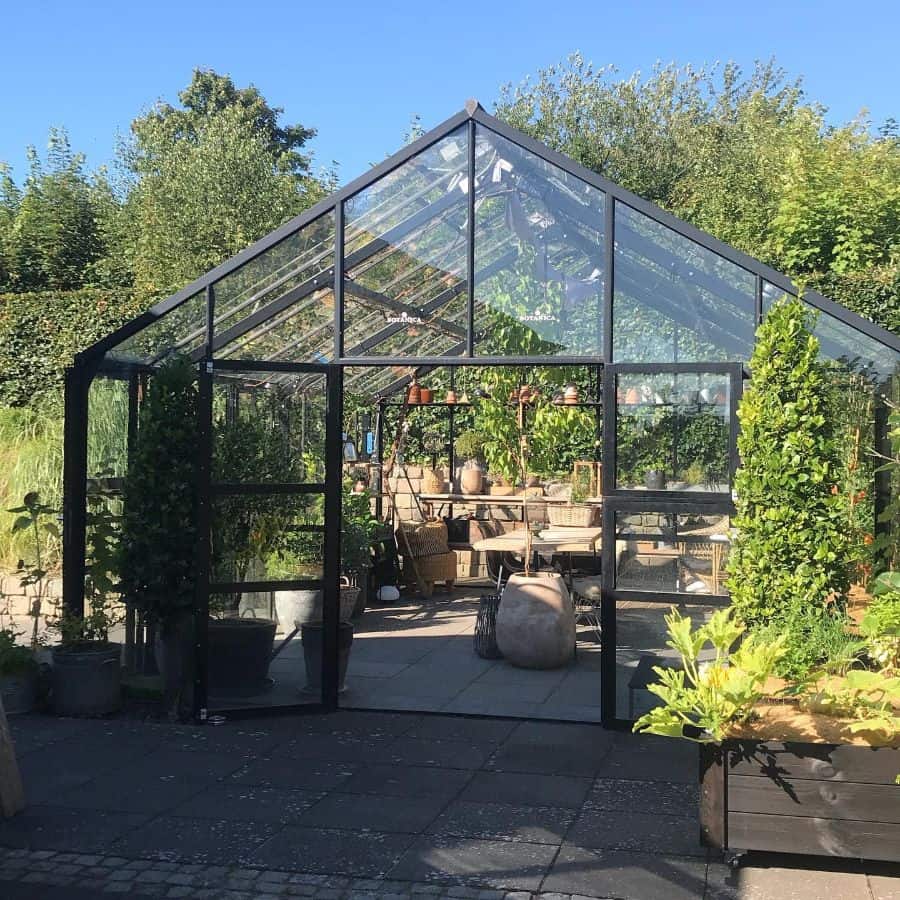 black frame glass greenhouse plants table and chairs