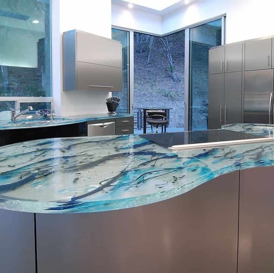 stainless steel kitchen with blue glass countertop