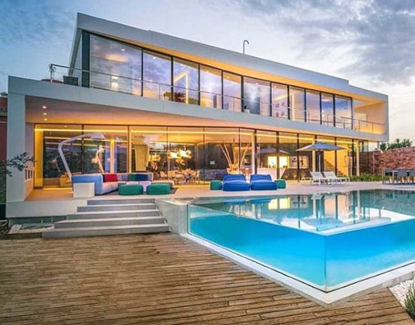 Glass Swimming Pool Outdoors With Wood Deck