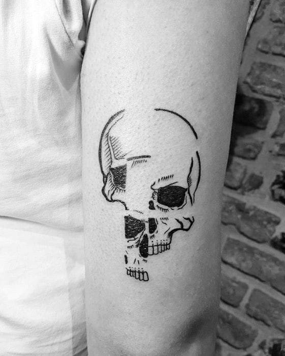 Glitch-style skull tattoo with fragmented black linework and missing sections, creating a pixelated and abstract appearance on the arm
