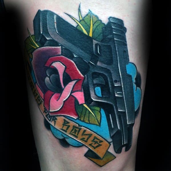 Colorful tattoo of a Glock pistol with a red rose, blue background, and a banner reading "Toys for Boys," blending realism with traditional tattoo style.
