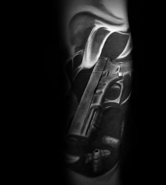 Realistic black and grey tattoo of a Glock pistol with bullets, surrounded by smoke-like shading for a dramatic and three-dimensional effect.