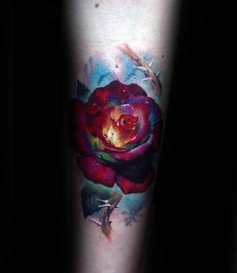 Colorful rose tattoo on a forearm, blending vibrant hues with realistic details