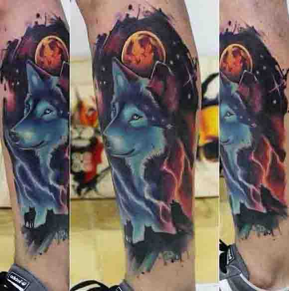 Tattoo of a wolf with a vibrant background featuring a full moon and colorful abstract shapes
