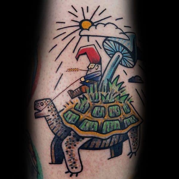 Tattoo of a gnome with a red hat riding a turtle with a mossy shell, holding a wheat stalk, with a mushroom and sun in the background.