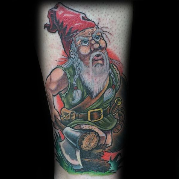 Tattoo of a fierce gnome with a red hat, long beard, and glasses, dressed in green, holding an axe with a determined expression.