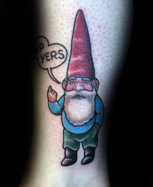 Tattoo of a cheeky gnome with a tall red hat, blue shirt, and green pants, flipping the finger with a speech bubble saying "UP YERS."