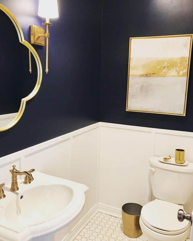 two tone blue and white powder room with gold accents 