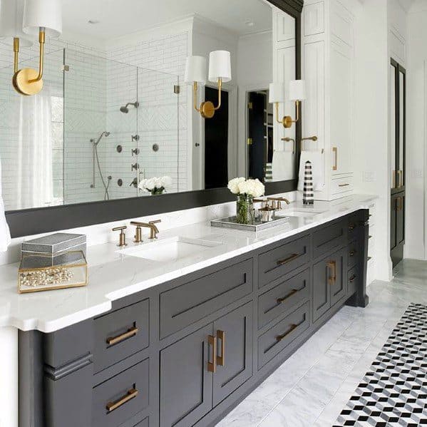 Modern bathroom with black double vanity, gold fixtures, and elegant wall sconces lighting.