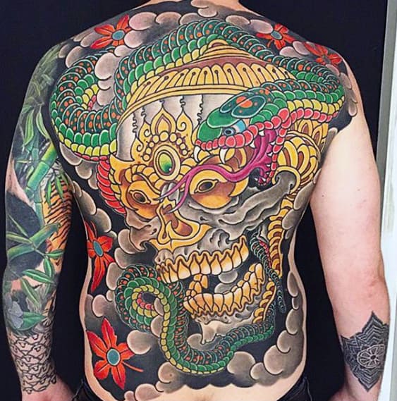 Detailed back tattoo of a colorful snake entwined with a golden skull and flowers
