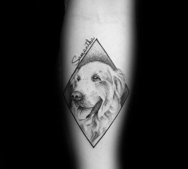 Fine-line Golden Retriever tattoo inside a diamond frame, featuring delicate shading, soft fur details, and a name inscription for a personal touch.