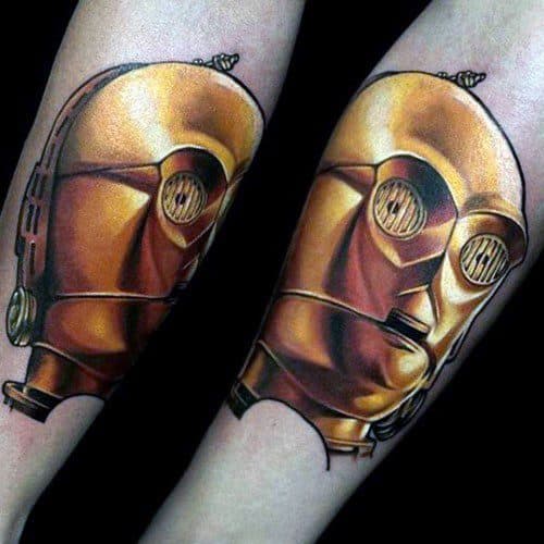 Realistic C-3PO tattoo with a torn effect, making the droid appear as if emerging from beneath the skin with detailed metallic shading.