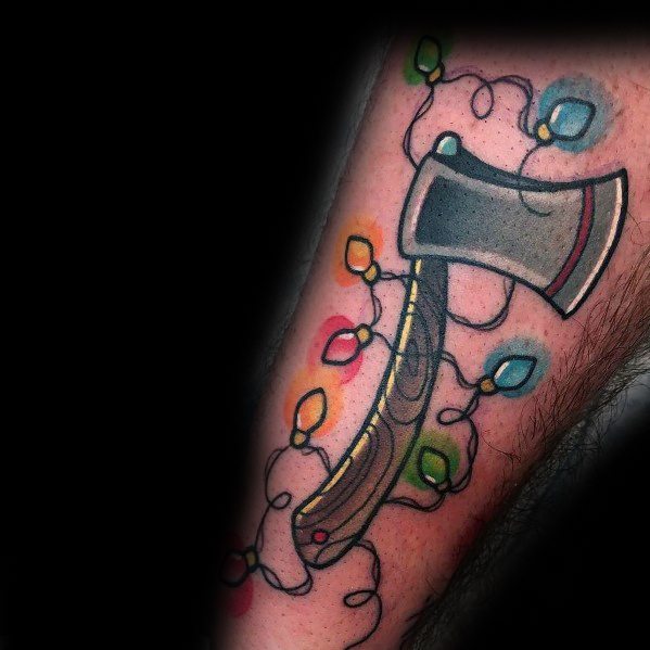 Christmas tattoo featuring a detailed axe wrapped in colorful holiday lights, blending a rugged aesthetic with festive elements for a unique holiday design.