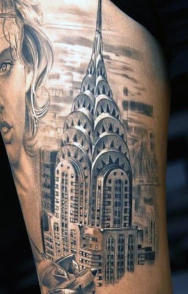 Realistic Chrysler Building tattoo with intricate details and shading, paired with a portrait for a distinctive, artistic style.