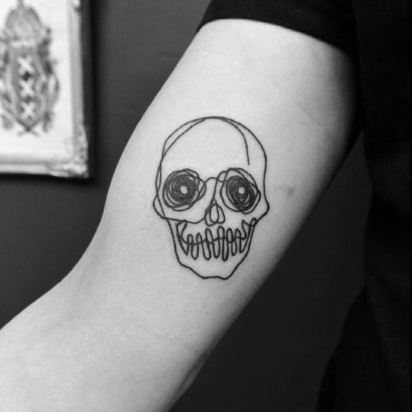 Abstract continuous line skull tattoo on the forearm, featuring bold black ink with swirling eye details for a unique and artistic look.