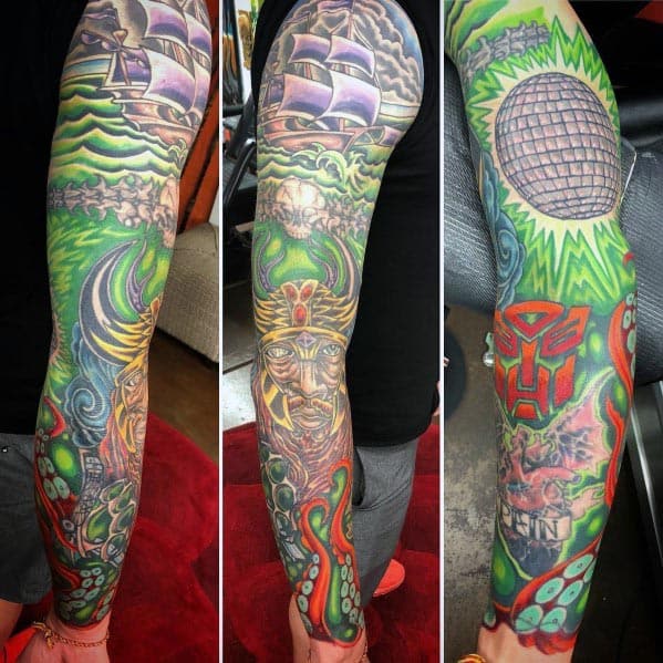 Vibrant full-sleeve tattoo featuring a disco ball, mythical figures, a pirate ship, and bold colors, blending fantasy and music themes.