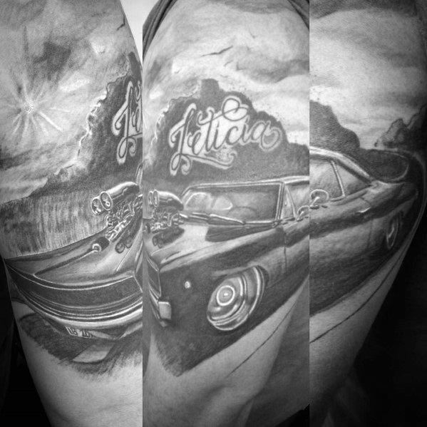 Black and grey tattoo sleeve featuring a Dodge muscle car with a supercharger, scenic background, and 'Felicia' script for a custom look.