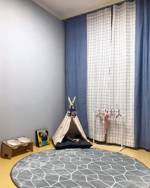 dog room with teepee dog house gray mat food and water bowls 